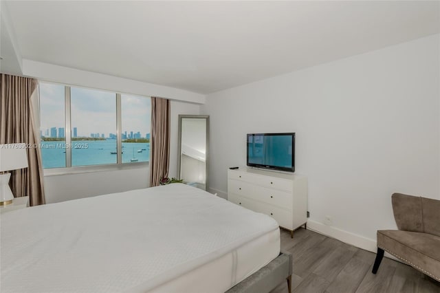 bedroom featuring wood finished floors and baseboards