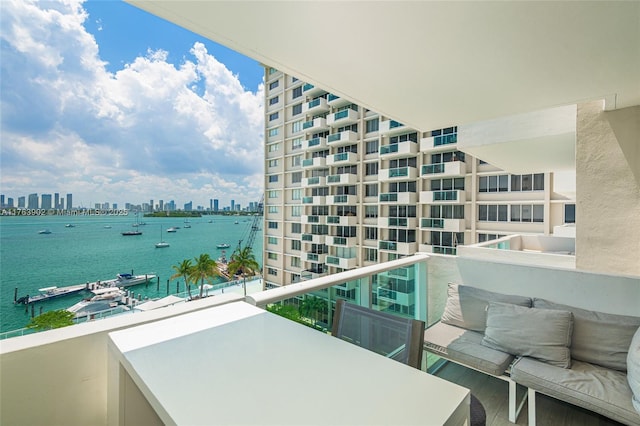 balcony featuring a city view and a water view