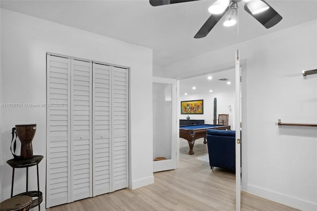 hall featuring light wood-style flooring and baseboards