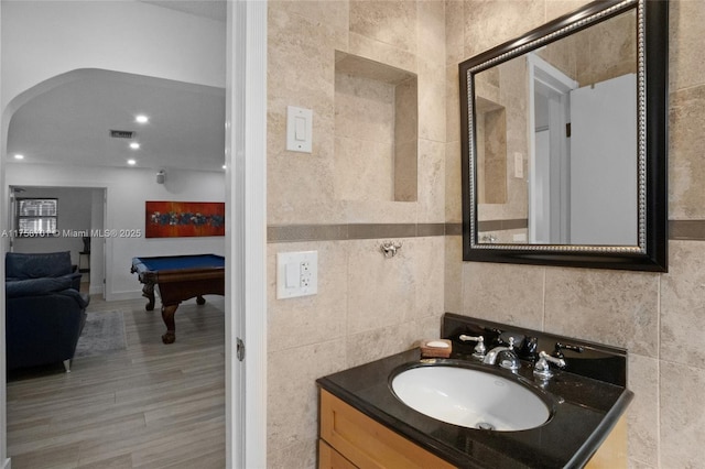 bathroom with vanity, visible vents, recessed lighting, pool table, and tile walls