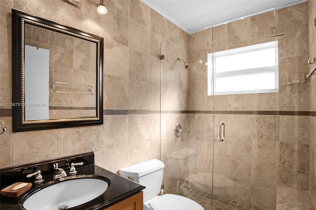 bathroom featuring tile walls, a shower stall, toilet, and vanity