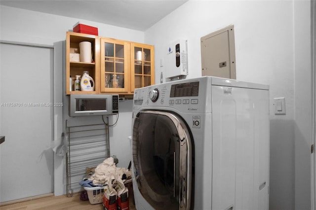 laundry room featuring electric panel, laundry area, washer / clothes dryer, and wood finished floors