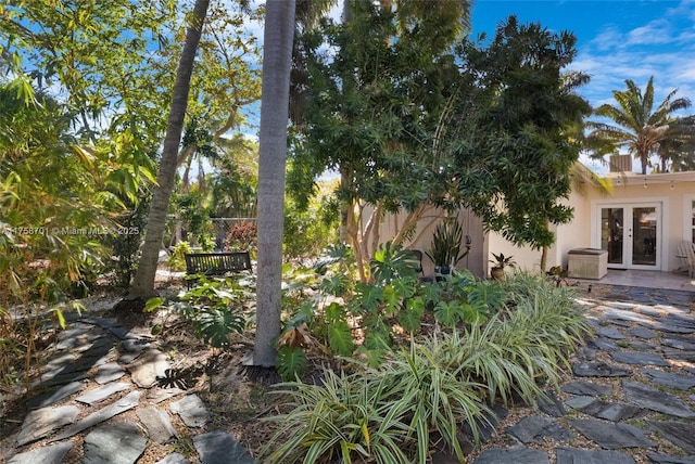 view of yard featuring french doors and fence