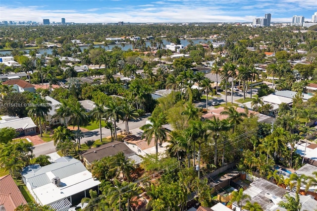 birds eye view of property with a water view and a view of city