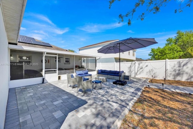 view of patio / terrace featuring an outdoor living space, fence, and a sunroom