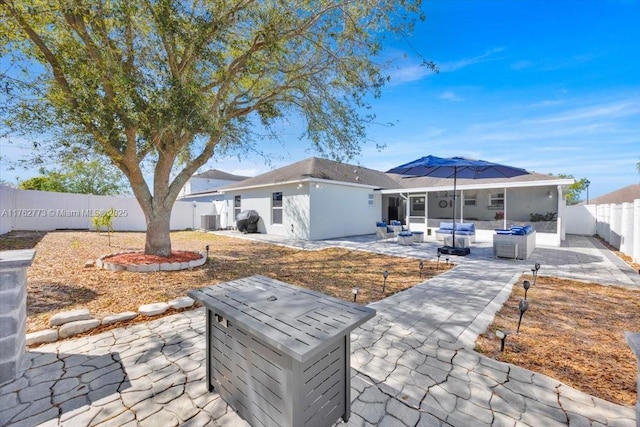 rear view of property featuring a patio, cooling unit, a fenced backyard, and an outdoor hangout area