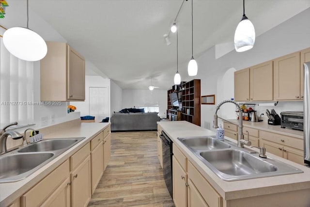 kitchen with light wood-style flooring, light brown cabinets, open floor plan, and a sink