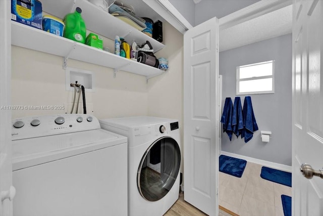 washroom featuring baseboards, independent washer and dryer, and laundry area