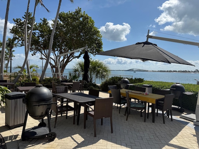 2451 Brickell Ave Unit 20N, Miami, FL 33129 - view of patio / terrace featuring outdoor dining space, a water view, and area for grilling
