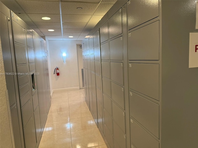 2451 Brickell Ave Unit 20N, Miami, FL 33129 - hall featuring a package area, recessed lighting, a drop ceiling, light tile patterned floors, and baseboards