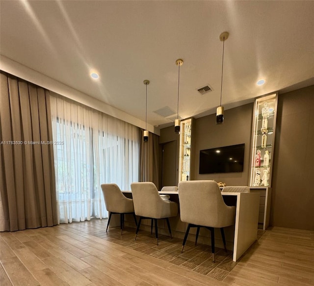 dining area with visible vents and wood finish floors