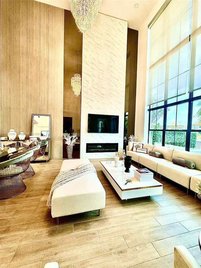 living room featuring a notable chandelier, a high ceiling, and wood finished floors