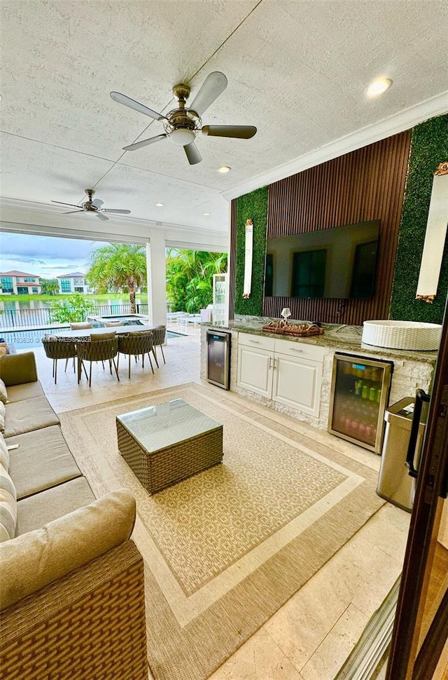 view of patio / terrace featuring ceiling fan, fence, wine cooler, outdoor dining space, and area for grilling