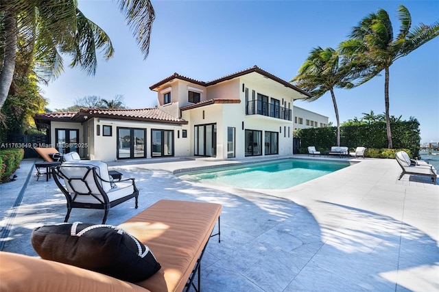 view of swimming pool featuring a patio, french doors, and a fenced in pool