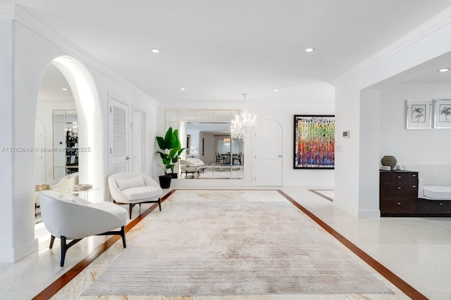 sitting room featuring wood finished floors, baseboards, an inviting chandelier, recessed lighting, and ornamental molding