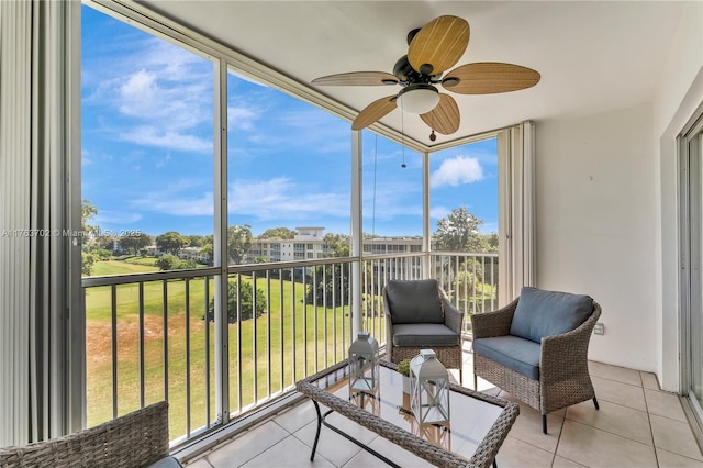 sunroom / solarium featuring a ceiling fan