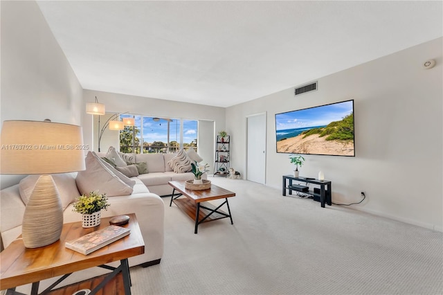 living area featuring visible vents and light colored carpet