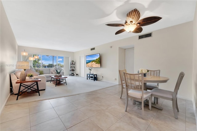 dining room with light tile patterned floors, visible vents, and a ceiling fan