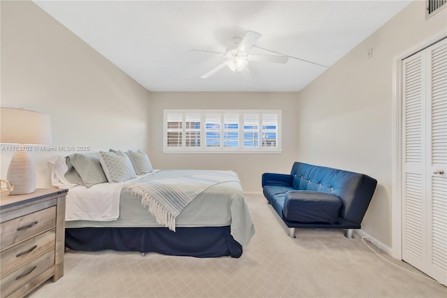 bedroom with visible vents, a ceiling fan, a closet, carpet flooring, and baseboards