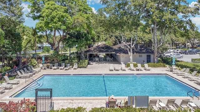 community pool featuring a patio and fence