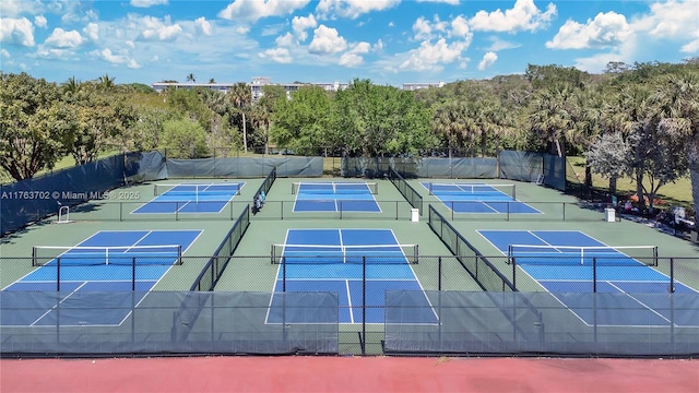 view of tennis court featuring community basketball court and fence