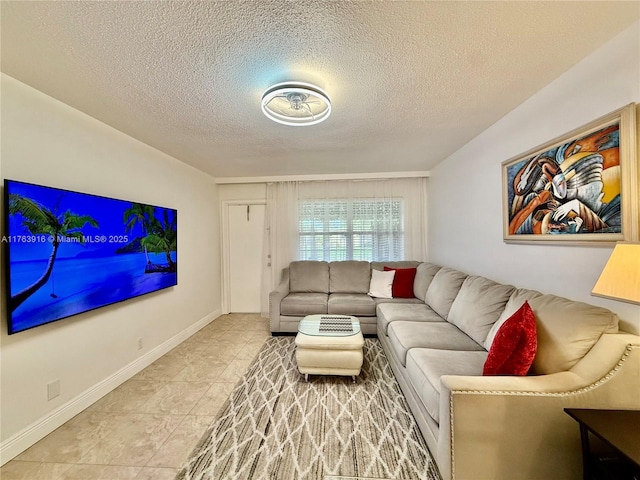 living room featuring a textured ceiling and baseboards