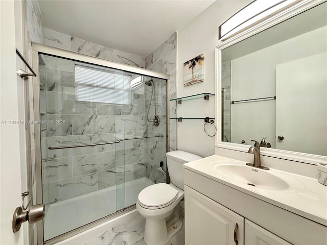 bathroom featuring vanity, toilet, marble finish floor, and a marble finish shower