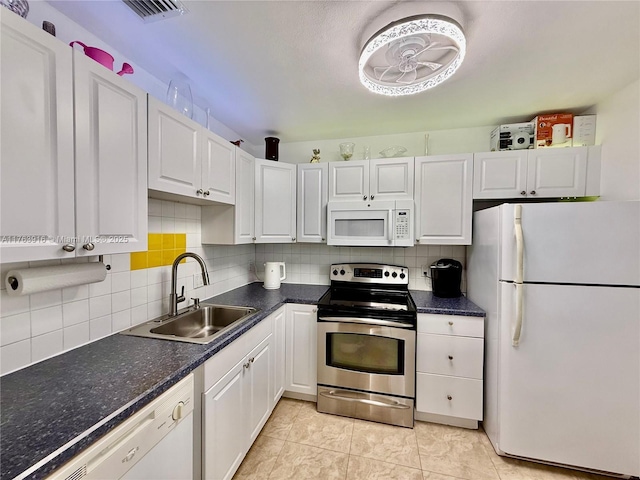 kitchen featuring decorative backsplash, white cabinets, white appliances, and a sink