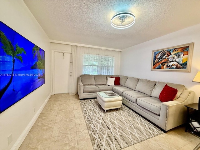 living area featuring a textured ceiling and baseboards