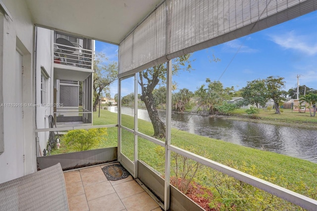 unfurnished sunroom with a water view