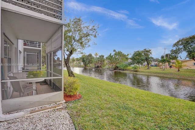 view of yard with a water view and a sunroom