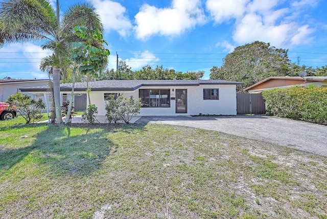 single story home featuring stucco siding and a front yard