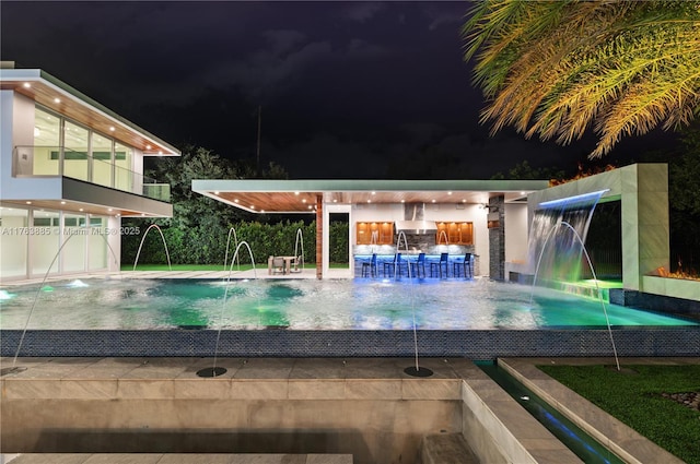 pool at night with an infinity pool