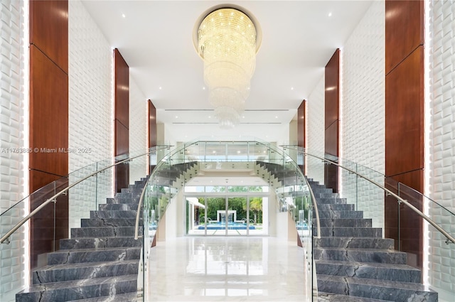 staircase with a chandelier