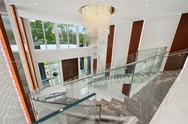 interior space with a chandelier and marble finish floor