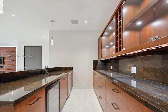 kitchen with dark stone counters, a sink, wine cooler, marble finish floor, and backsplash