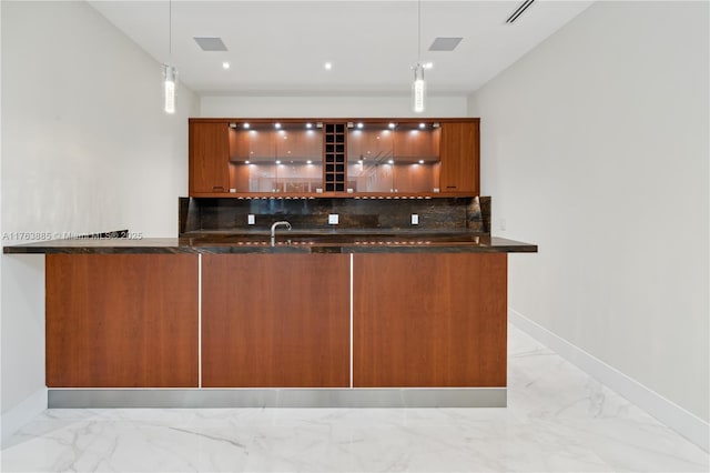 bar featuring decorative backsplash, hanging light fixtures, baseboards, and marble finish floor