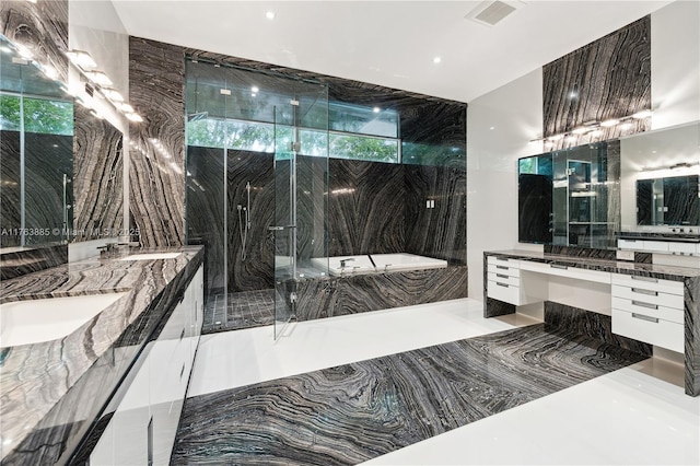 bathroom featuring a sink, visible vents, a garden tub, and a healthy amount of sunlight