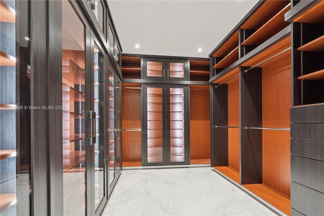 spacious closet with marble finish floor