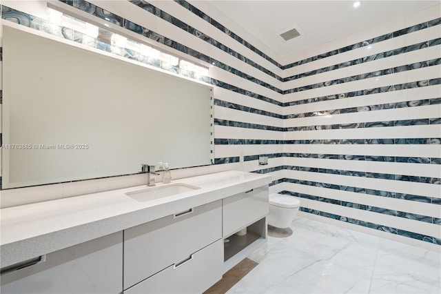 full bathroom with visible vents, toilet, marble finish floor, and vanity