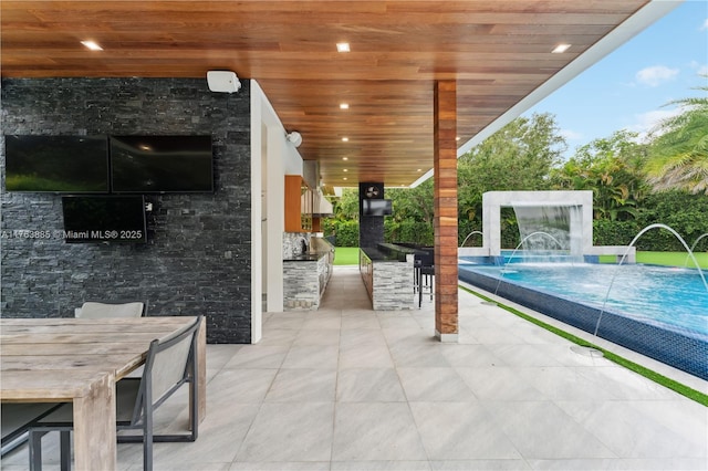 view of patio / terrace featuring outdoor dining space and outdoor wet bar