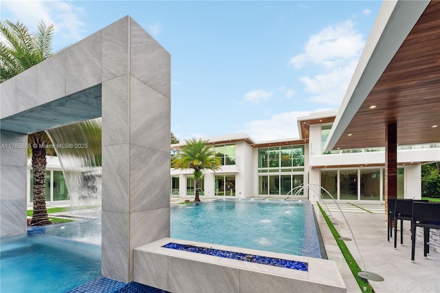 outdoor pool with a patio area