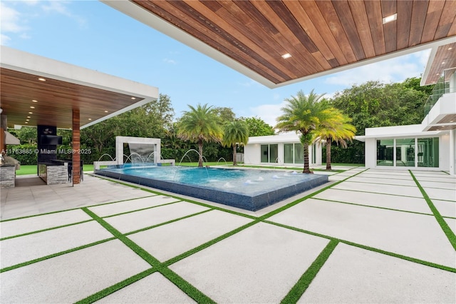 pool featuring a patio and an outdoor structure