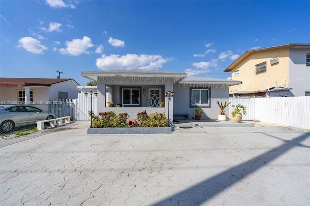 view of front of home featuring a gate, stucco siding, and fence