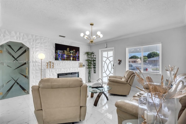 living area featuring a textured ceiling, marble finish floor, and a chandelier