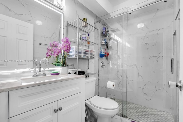 full bath with vanity, toilet, marble finish floor, and a marble finish shower