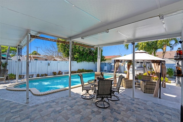 view of pool with a gazebo, a patio area, a fenced backyard, and a fenced in pool