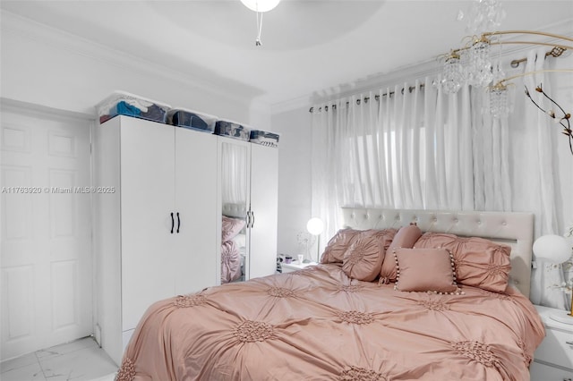 bedroom with a closet, marble finish floor, and crown molding