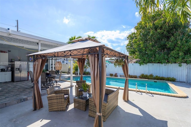 view of swimming pool featuring a gazebo, a fenced in pool, a patio, and fence