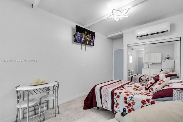 bedroom featuring a wall unit AC, light tile patterned flooring, and baseboards